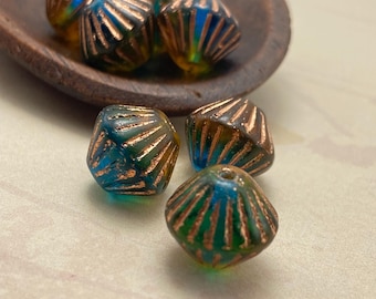 Eight Czech glass bicone beads with teal blue and orange colouring and copper lines, displayed on a grey dish and cream.