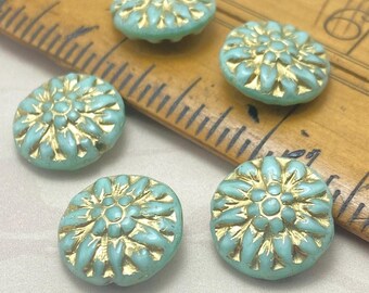 Five turquoise green dahlia flower beads with gold wash, displayed against a ruler for scale.
