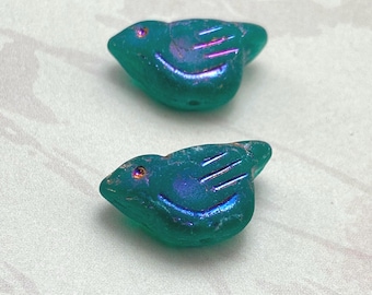 Two matte emerald green Czech bird beads with rainbow wash effect displayed on a plain background.
