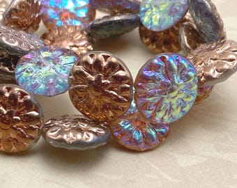 Five Czech glass dahlia flower beads with violet and copper finish in a wooden dish, two beads purple and three bronze-toned.