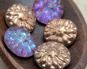 Five Czech glass dahlia flower beads with violet and copper finish in a wooden dish, two beads purple and three bronze-toned.