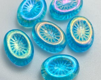 Six Czech glass kiwi beads in transparent aqua blue with starburst patterns, shown on a white background.