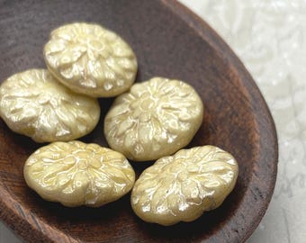 Five champagne ivory lustre Czech glass dahlia flower beads displayed in a wooden bowl.