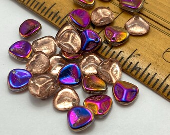 Twenty-five Czech glass rose petal beads in magic purple copper with iridescent finish, shown next to a wooden ruler.