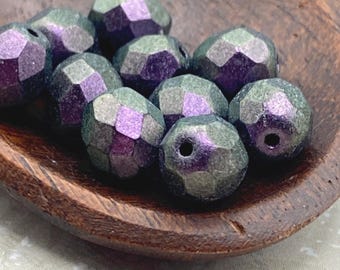 Ten purple and mint Czech glass faceted round beads, each 8mm, nestled in a wooden bowl.