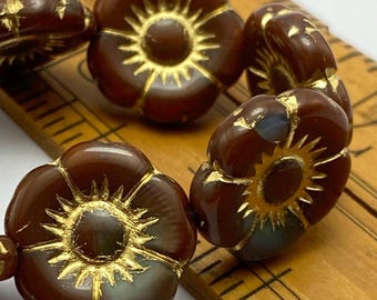 Brown and teal Czech glass flower beads with gold wash in sunburst pattern, arranged on plain white background.