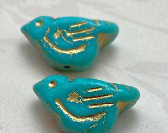 Two tiffany green Czech bird beads with gold wash detail, shown on a white background.