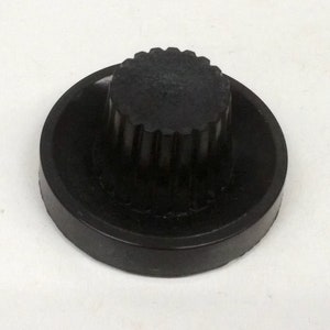 May include: A black rubber knob with a ridged top and a smooth, flat base.