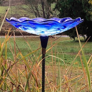 Cobalt Blue Bird Bath seated on a painted black rebar.