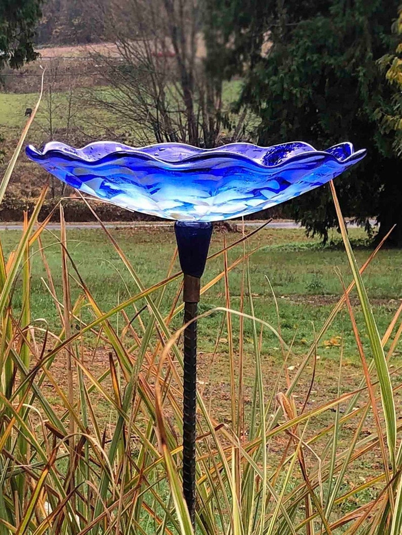 Cobalt Blue Bird Bath seated on a painted black rebar.