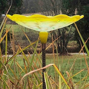 Lemon Yellow Bird Bath on top of rebar.