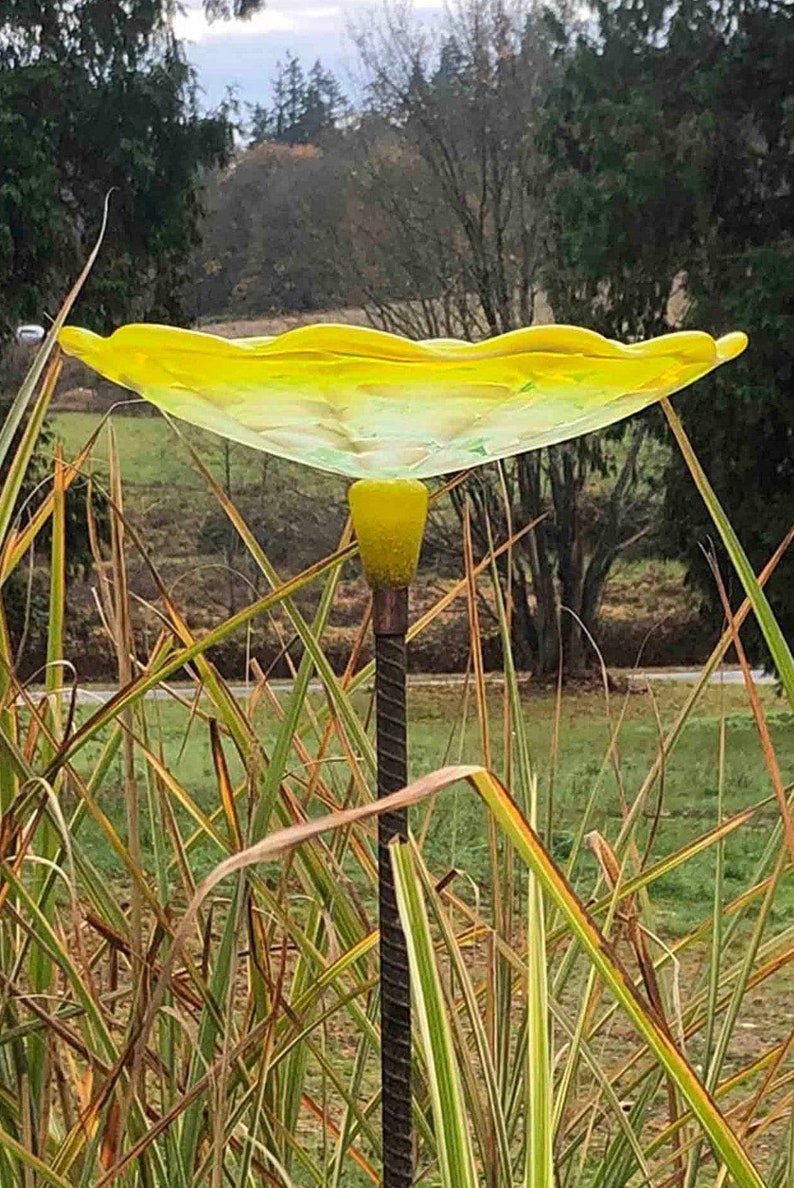 Lemon Yellow Bird Bath on top of rebar.