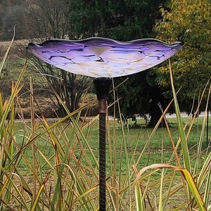 Purple Bird Bath seated on top of Rebar.