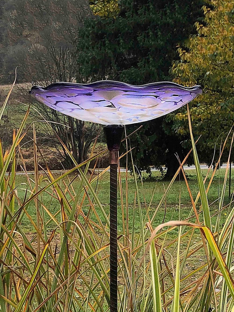 Purple Bird Bath seated on top of Rebar.