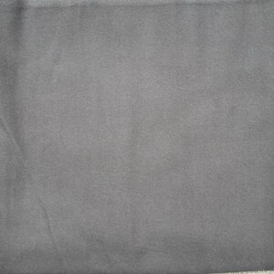 May include: A solid dark gray fabric swatch. The fabric has a smooth, even texture.