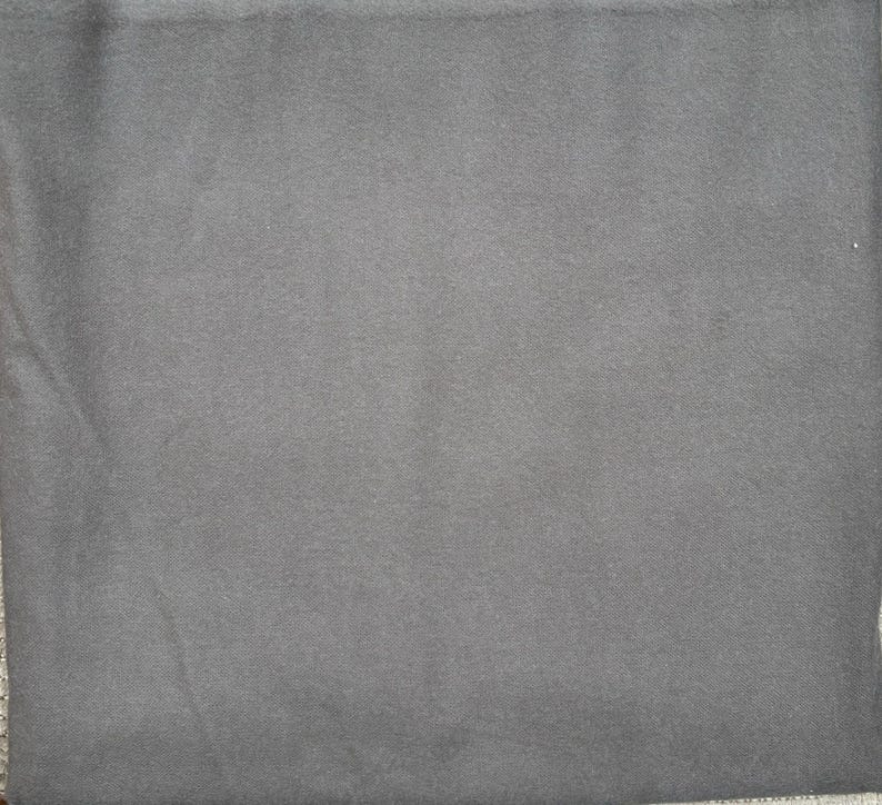 May include: A solid dark gray fabric swatch. The fabric has a smooth, even texture.