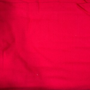 May include: A solid red fabric swatch. The fabric is smooth and has a slight sheen.