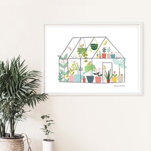 May include: A white framed print of a colourful illustration of a greenhouse filled with plants and flowers. The text "Sally Paine" is at the bottom of the print.