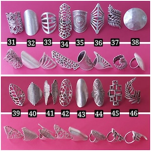 May include: A set of 46 silver rings with various designs, including geometric, floral, and leaf patterns. The rings are arranged in three rows, with numbers 31-38, 39-46, and 1-8 below each row.