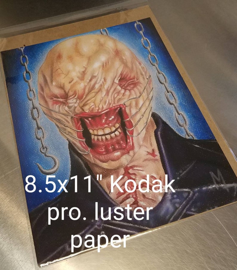 May include: A detailed drawing of a monstrous creature with a stitched-up mouth and chains, printed on 8.5x11" Kodak pro. luster paper.