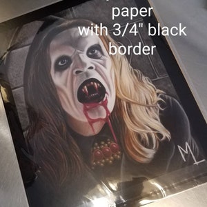 May include: Fuji archival paper print with a 3/4" black border. The artwork depicts a vampire with blood dripping from its mouth. The vampire has long blonde hair and is wearing a dark outfit. The print is signed.