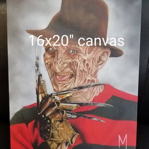 May include: A 16x20 inch canvas painting of Freddy Krueger from the Nightmare on Elm Street movie franchise. He is wearing a red and black striped sweater, a brown fedora, and a glove with blades. He has a disfigured face with a sinister smile.