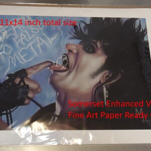 May include: A black and white illustration of a person with dark hair and a black leather glove. The person is licking their finger and the background is blue with the words "FALSO METAL" written in white. The image is printed on Somerset Enhanced Velvet Fine Art Paper. The print is 11 inches by 14 inches.