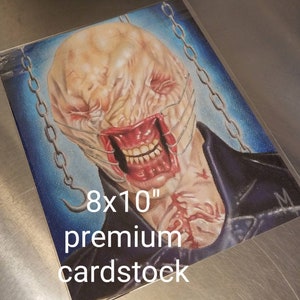 May include: A hand-drawn illustration of a monstrous creature with a stitched-up mouth and a chain around its neck. The illustration is on 8x10 inch premium cardstock.