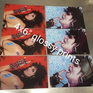 May include: Set of four 4x6 inch glossy prints featuring a black and white illustration of a person with long black hair. The person is wearing a black leather jacket and has a tongue sticking out. The text "Death to False Metal" is written in blue and white on a blue background.
