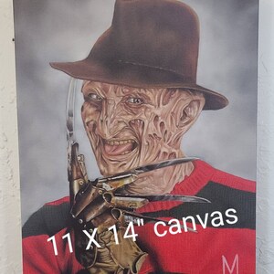 May include: A painting of Freddy Krueger, the iconic horror character from the Nightmare on Elm Street franchise. He is depicted with his signature red and green striped sweater, brown fedora, and a glove with razor-sharp blades. The painting is on a 11 x 14 inch canvas.