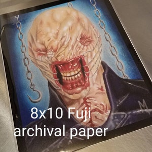 May include: A drawing of a monstrous creature with a stitched-up face and a chain around its neck. The drawing is on 8x10 Fuji archival paper.