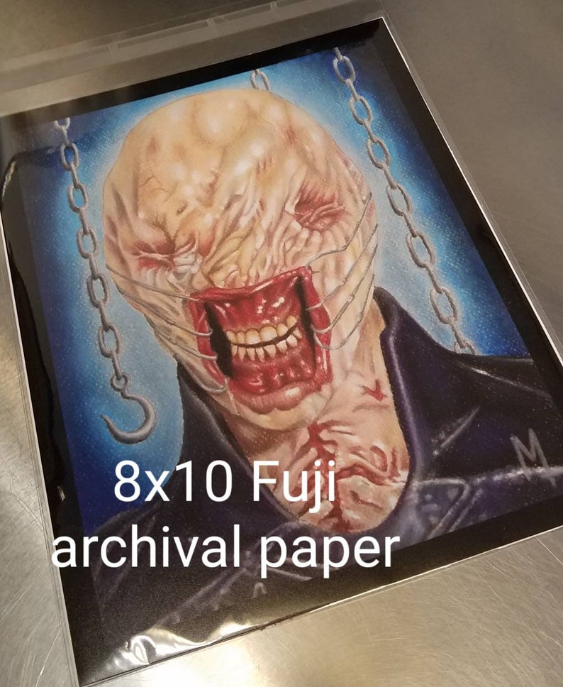May include: A drawing of a monstrous creature with a stitched-up face and a chain around its neck. The drawing is on 8x10 Fuji archival paper.