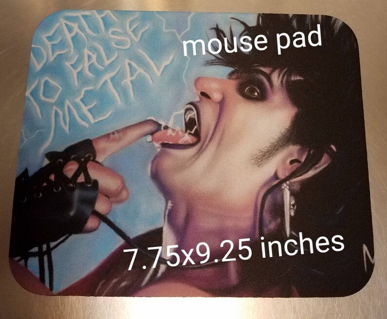 May include: A mouse pad featuring a colorful illustration of a person with long black hair, wearing a black leather glove, with the text "Death to False Metal" and "mouse pad" printed on the pad. The pad measures 7.75x9.25 inches.