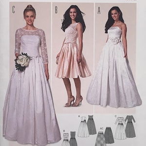 Op de afbeelding: Een Burda Style naaipatroonpakket met drie jurk ontwerpen. De voorkant toont afbeeldingen van de afgewerkte jurken, waaronder een strapless jurk en een jurk met kanten mouwen. Maten: EUR 34-44 en US 8-18.