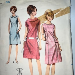 May include: Vintage Butterick sewing pattern, size 16, with illustrations of three dresses. The pattern envelope shows a light blue dress, a pink dress, and a pink and white checkered dress. The bust size is 91 cm.