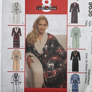 May include: A McCall's 9636 sewing pattern envelope for a robe with 8 great looks. The front features a central image of a person wearing a dark robe with a white deer print and a cream shawl collar, surrounded by illustrations of various robe styles.