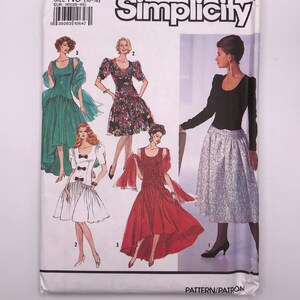 Peut inclure: Patron de couture Simplicity numéro 1002, taille N5 (10-18), présentant quatre modèles de robes différents. Les robes sont présentées sur quatre mannequins. La première robe est une robe verte avec un châle blanc. La deuxième robe est une robe à imprimé floral. La troisième robe est une robe rouge avec une jupe asymétrique. La quatrième robe est un haut noir avec une jupe blanche.
