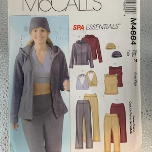 May include: McCall's Spa Essentials sewing pattern. The pattern features a woman wearing a gray zip-up jacket, pants, and a hat. The pattern also includes illustrations of other spa-related clothing items. The pattern number is M4664.