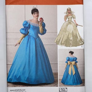 May include: Simplicity sewing pattern 1728 D5 for a princess-style gown. The envelope displays a blue dress with puff sleeves, a white lace collar, and yellow sleeves. Includes illustrations of the front and back views, plus a gold gown option.