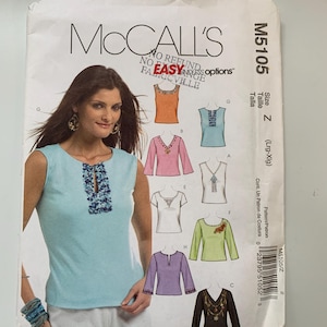 May include: A sewing pattern for a sleeveless top with a keyhole neckline and embroidery detail. The pattern is from McCall's and is size Z (Large-Extra Large).
