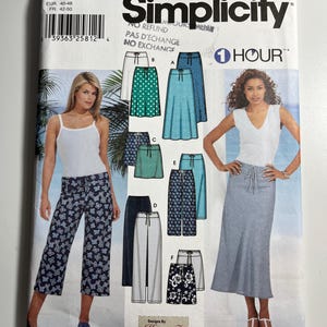 May include: A Simplicity 7229 sewing pattern envelope for size R5 14-22. The front displays illustrations of various skirts and trousers with drawstring waists, labelled A through F. It includes photos of two models wearing the finished garments.