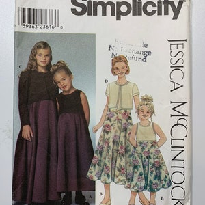 May include: Simplicity sewing pattern number 9018 for girls' dresses. The pattern includes two dress styles, one with a solid purple skirt and the other with a floral print skirt. The pattern is for sizes 3, 4, 5, and 6. The pattern is by Jessica McClintock.