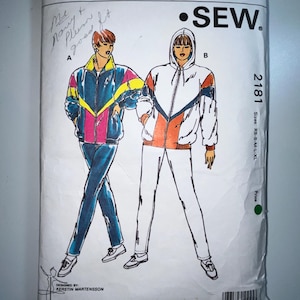 May include: A vintage Kwik Sew sewing pattern packet, pattern 2181, featuring illustrations of tracksuits. The packet shows a blue, pink, and yellow tracksuit and a white, orange, and navy tracksuit. The sizes are XS-S-M-L-XL.