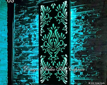 May include: A black metal wall decor with a teal-colored, intricate, floral design. The design is cut out of the metal, creating a light-up effect. The wall decor is illuminated with blue light, creating a vibrant and modern look.