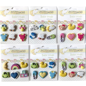 May include: Six packages of baby-themed buttons. Each package features a variety of colorful buttons, including a pacifier, sheep, baby clothes, and a safety pin. The packages are labeled "Baby Hugs Collection" with the brand name "Buttons Galore & More".