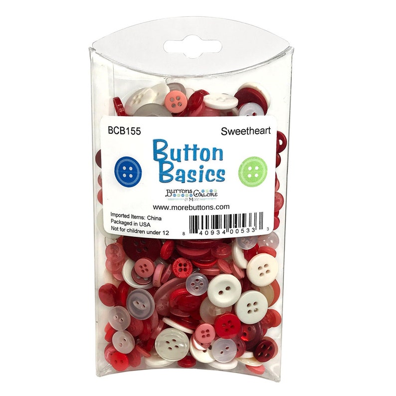 May include: A clear plastic bag filled with a variety of red, white, and pink buttons. The bag has a label that reads "Button Basics" and "Sweetheart". The label also includes the product code "BCB155" and the website address "www.morebuttons.com".