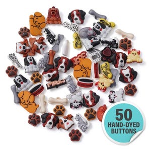 May include: A collection of 50 hand-dyed buttons in various shapes and colors, including dogs, paw prints, bones, and food bowls. The buttons are primarily brown, white, and black, with some yellow and red accents. The buttons are scattered on a white background.