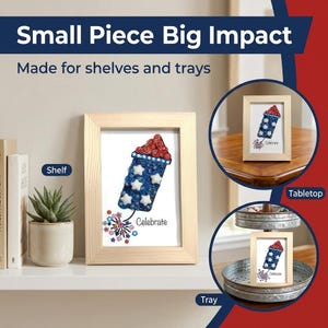 May include: A framed artwork featuring a patriotic firework design with red, white, and blue accents. The artwork is displayed on a shelf, tabletop, and tray, with the text "Celebrate" at the bottom. The image also includes the text "Small Piece Big Impact" and "Made for shelves and trays".