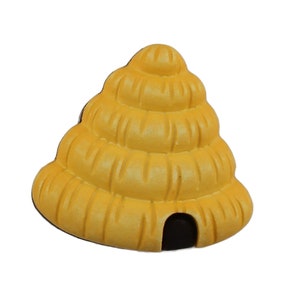May include: A yellow beehive shaped ornament with a small black entrance hole.