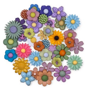 May include: A collection of colorful flower-shaped embellishments in various sizes and hues, including pink, blue, yellow, and purple. These decorative floral accents have a flat back and are made of a smooth material.